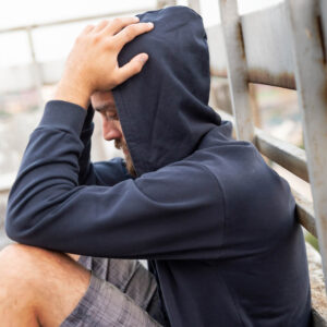 Man sitting against railing unsure of what to do to get through depression 1000