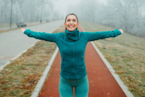 Woman with arms wide open excited about life 600