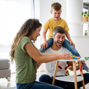 Happy family playing board game together and enjoying time 1000