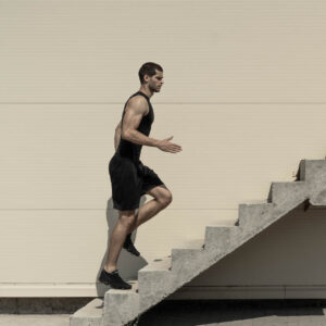 Man running up flight of stairs accomplishing a goal 1000